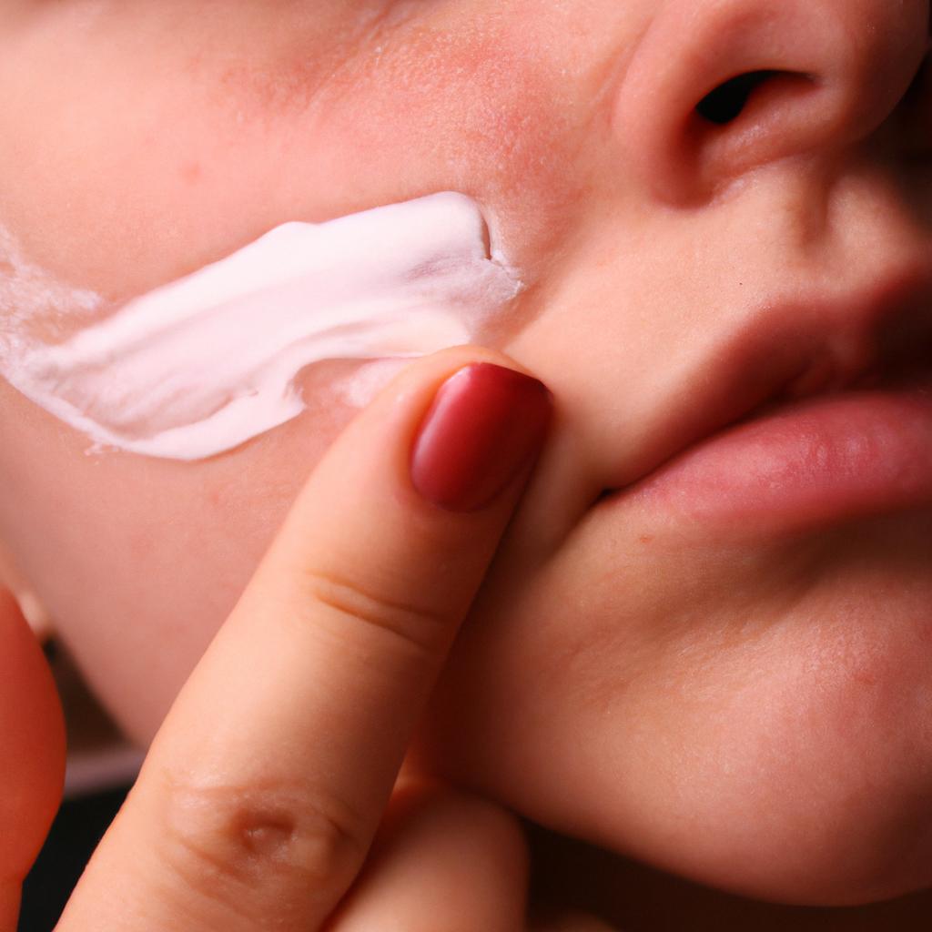 Person applying moisturizer on face